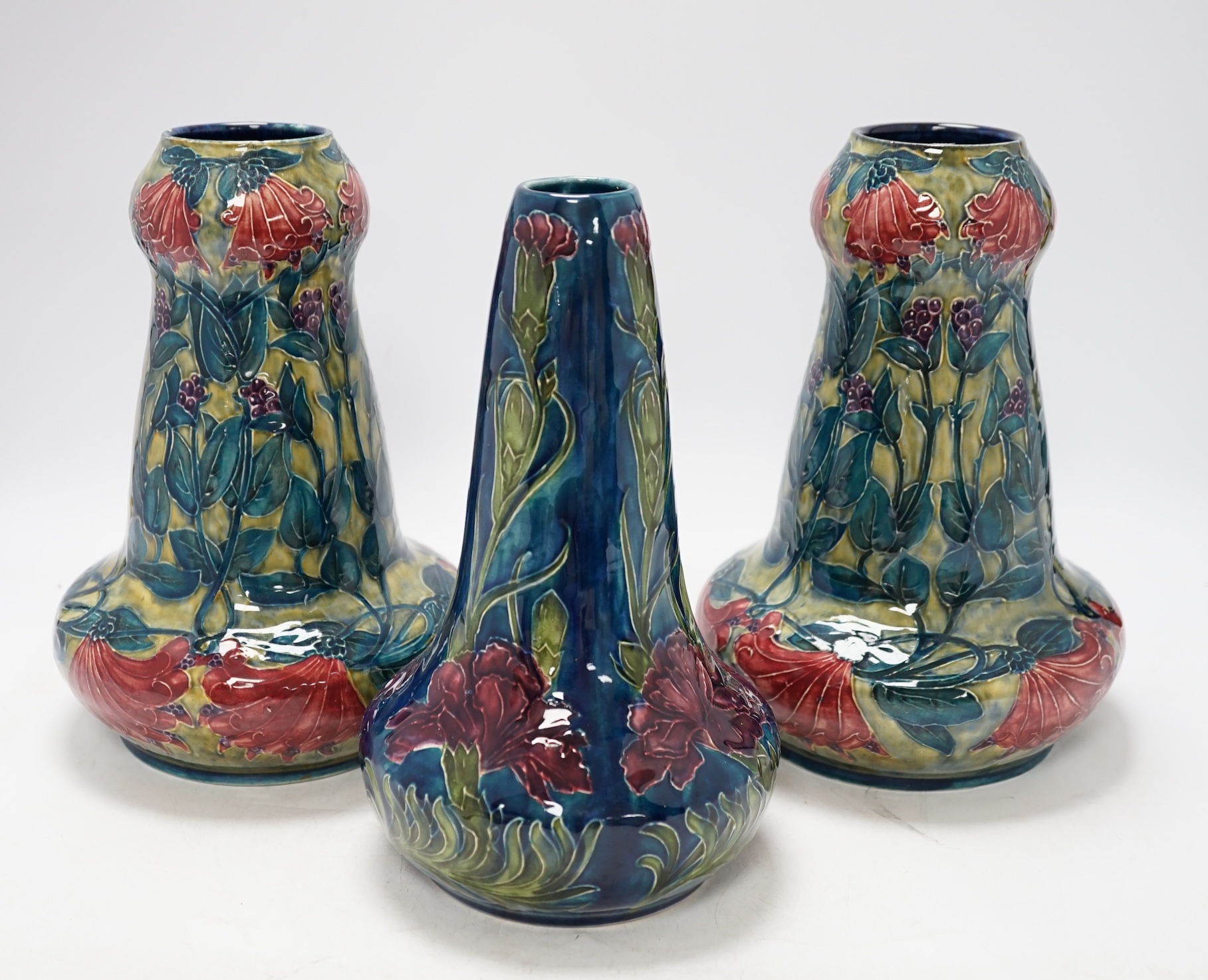A pair of Hancock & Sons Morrisware vases, and another, designed by George Cartlidge, decorated with stylised flowers, 24cm high. Condition - fair to good, crazing throughout